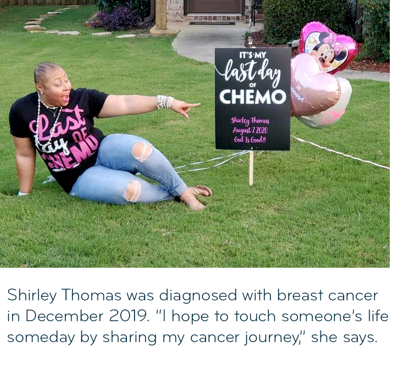 a woman sits next to a yard sign celebrating her last chemo treatment
