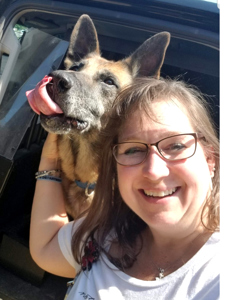 A woman poses with a police service dog